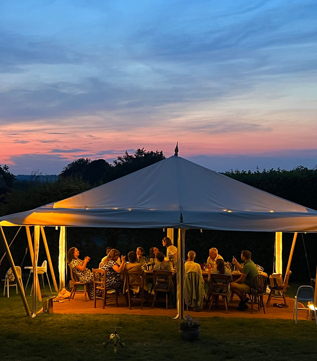 Dinner beneath a marquee at sunset